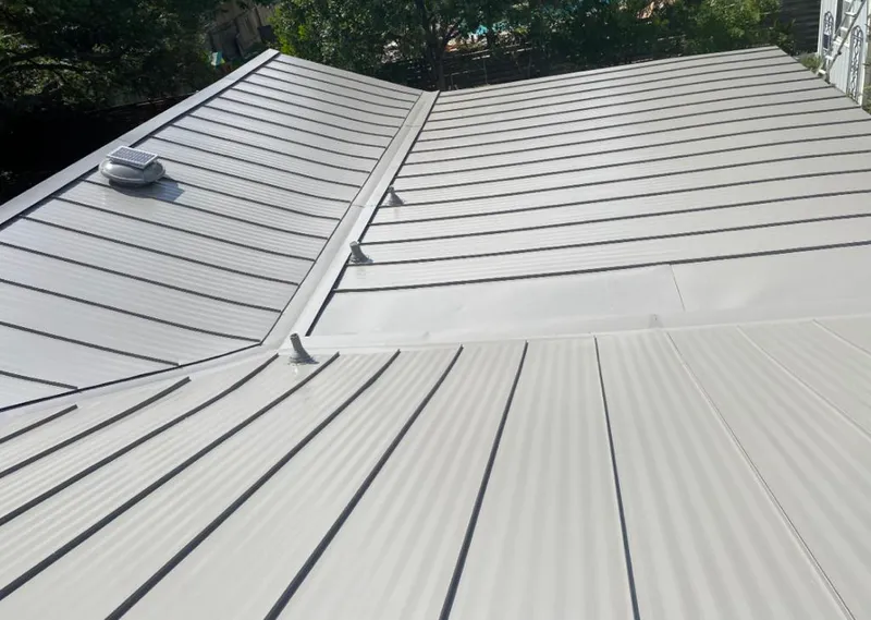 Solar attic fan installed on a metal roof for Roof Ventilation in Crest Hill